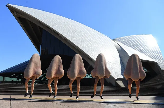 Cast members in costume from Opera Australia dance during a sneak preview from their production of Shostakovich's The Nose outside the Sydney Opera House in Sydney, Australia, 22 August 2017. (Photo by David Moir/EPA)