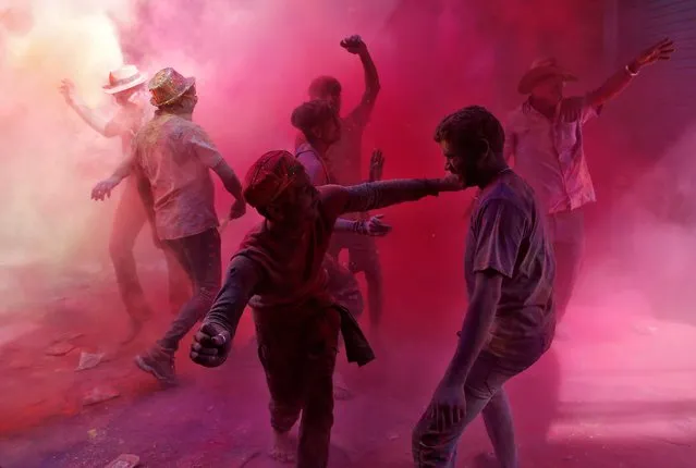 People dance as they throw coloured powder at each other during Holi, the festival of colours, celebrations in Kolkata, India March 10, 2020. (Photo by Rupak De Chowdhuri/Reuters)