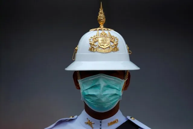 A Thai Royal Guard wears a mask while he stands inside the Royal Palace in Bangkok, Thailand on February 5, 2020. (Photo by Jorge Silva/Reuters)