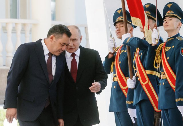 This pool photograph distributed by Russian state owned agency Sputnik shows Russia's President Vladimir Putin and his Kyrgyz counterpart Sadyr Japarov attending a welcoming ceremony prior to their talks in Bishkek on October 12, 2023. (Photo by Sergei Karpukhin/Pool via AFP Photo)