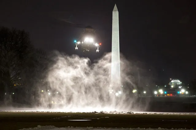 Snow billows in the air as the Marine One helicopter, carrying President Barack Obama, lands on the South Lawn of the White House, on his return from Chicago, Thursday, February 19, 2015, in Washington. (Photo by Jacquelyn Martin/AP Photo)