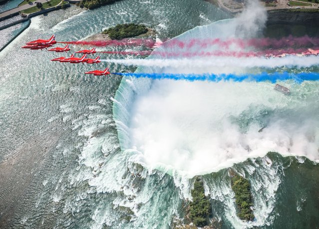 Nine jets from the UK's Royal Air Force Aerobatic Team, the Red Arrows, soar over Niagara Falls, Ontario, Canada on September 11, 2024, in a spectacular flypast also involving an historic Lancaster bomber. (Photo by Cpl Phil Dye/UK MOD Crown copyright)