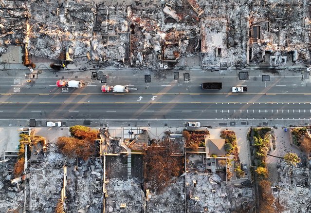 An aerial view of repair vehicles near beachside homes that burned in the Palisades Fire as wildfires cause damage and loss through the LA region on January 15, 2025 in Malibu, California. Multiple wildfires fueled by intense Santa Ana Winds are still burning across Los Angeles County, with at least 25 dead, more than 12,000 structures destroyed or damaged, and 40,000 acres burned. More than 88,000 people remain under evacuation orders as high winds are forecast. (Photo by Mario Tama/Getty Images)
