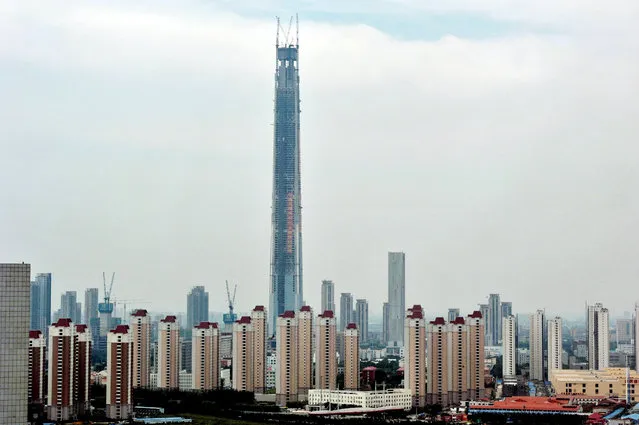 The 117-story Tianjin 117 Tower is under construction in Tianjin, China, 8 September 2015. The 117-story Tianjin 117 Tower was capped Tuesday (8 September 2015) morning in Tianjin. With the main structure reaching 596.5 meters, it has become the second-tallest building in the world, only next to Burj Khalifa in Dubai, United Arab Emirates. Construction on the tower, which has a floor area of 847,000 square meters, was launched seven years ago. (Photo by Imaginechina/Splash News)