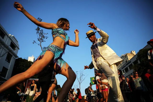 Dancers perform ahead of the arrival of the Olympic torch relay in Praca Maua on August 4, 2016 in Rio de Janeiro, Brazil. (Photo by Mario Tama/Getty Images)