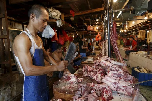 A butcher cuts meat at his stall at a traditional market in Jakarta, Indonesia, September 9, 2015. Indonesia will seek to import cattle from a broader range of countries than at present, the chief economics minister said on Wednesday, as part of efforts to reduce the cost of beef, which has contributed to keeping inflation high. (Photo by Nyimas Laula/Reuters)