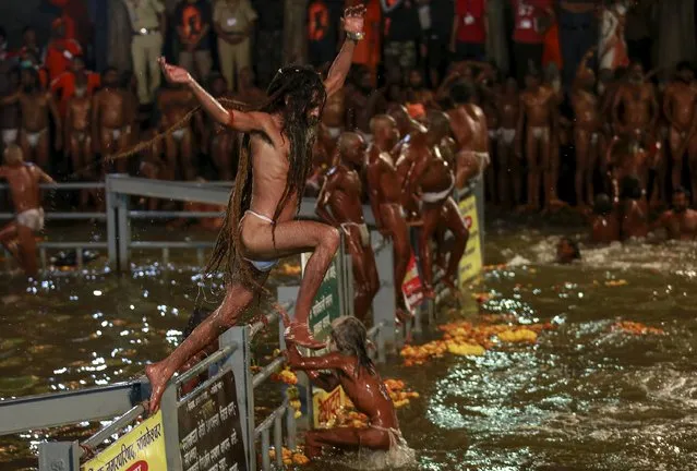 A Naga Sadhu, or Hindu holy man, jumps in a holy pond during the second “Shahi Snan” (grand bath) at “Kumbh Mela”, or Pitcher Festival, in Trimbakeshwar, India, September 13, 2015. (Photo by Danish Siddiqui/Reuters)