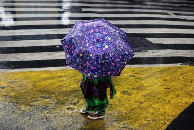 A woman walks on a street on a rainy day, after cyclone Nisarga made its landfall on the outskirts of the city, in Mumbai, India, June, 3, 2020. (Photo by Francis Mascarenhas/Reuters)