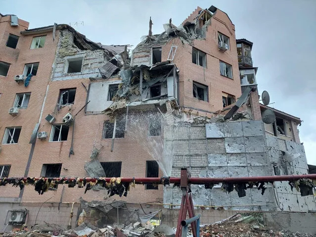 In this photo posted by the mayor of Mykolaiv on his Telegram channel, a residential building is seen damaged following night shelling in Mykolaiv, Ukraine, Sunday, October 23, 2022. A nearby 10-story residential building was also damaged. The windows and doors were blown out by debris and the blast wave, and the balconies were damaged. No victims reported. (Photo by Operational Command South via AP Photo)