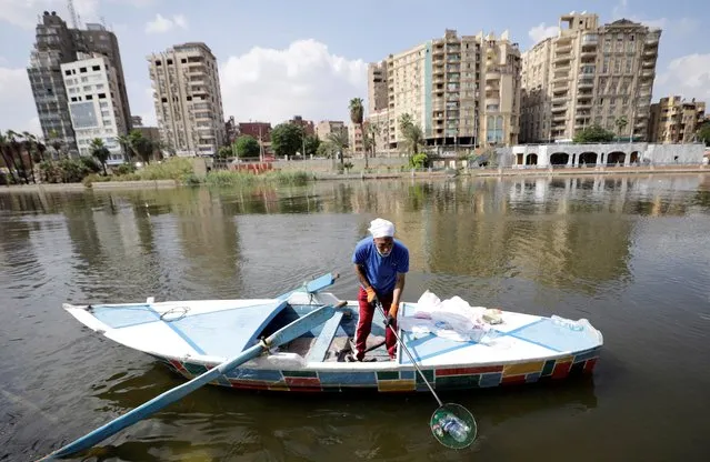 Fisherman Mohamed Nasar, 59, uses his boat to collect plastic garbage from the Nile river for The VeryNile NGO, three generations of Nassar's family are taking part in the environment friendly initiative in Giza, Egypt on October 19, 2022. (Photo by Mohamed Abd El Ghany/Reuters)