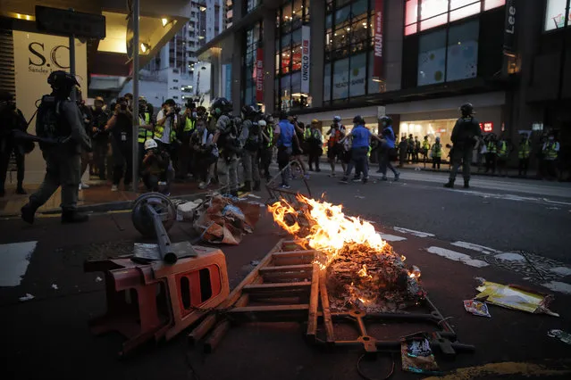Protesters against the new security law start a fire to block traffic during a march marking the anniversary of the Hong Kong handover from Britain to China, Wednesday, July. 1, 2020, in Hong Kong. Hong Kong marked the 23rd anniversary of its handover to China just one day after China enacted a national security law that cracks down on protests in the territory. (Photo by Kin Cheung/AP Photo)