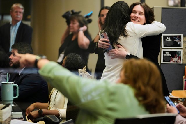 NASA employees react on Tuesday, March 18, 2025, at Johnson Space Center in Houston after watching astronauts splash down off the coast of Florida. (Photo by Ashley Landis/AP Photo)