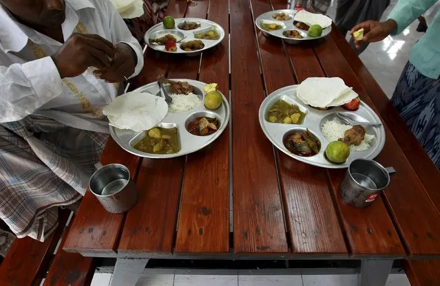 Rohingya Muslims who were trafficked eat together during an Eid-al-Adha celebration at a shelter in Pathum Thani province, on the outskirts of Bangkok, Thailand, September 24, 2015. Muslims across the world celebrate the annual festival of Eid al-Adha or the Feast of the Sacrifice. (Photo by Chaiwat Subprasom/Reuters)