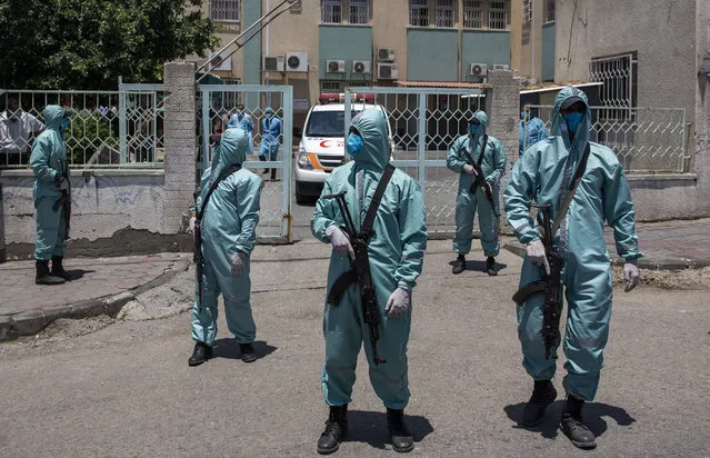 Palestinian Hamas police officers wear protective suits as they take part in a simulation of possible coronavirus infections in Gaza City, Saturday, July 18, 2020. (Photo by Khalil Hamra/AP Photo)