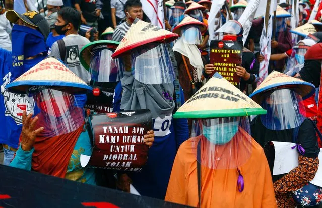 Farmers protest outside the Indonesian Parliament against cancellation of an “omnibus bill” that aims to revise dozens of existing laws to ease the way for investment in Southeast Asia's largest economy in Jakarta, Indonesia, July 16, 2020. (Photo by Ajeng Dinar Ulfiana/Reuters)