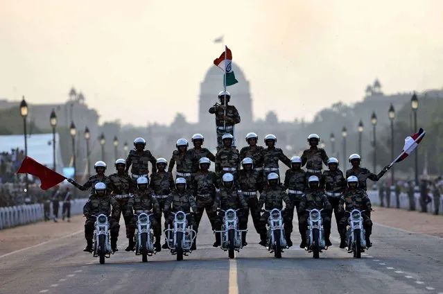 Indian army soldiers perform a daredevil motorcycle stunt during a parade to mark the 50th anniversary of the India-Pakistan war of 1965, in New Delhi, India, Sunday, September 20, 2015. (Photo by Tsering Topgyal/AP Photo)