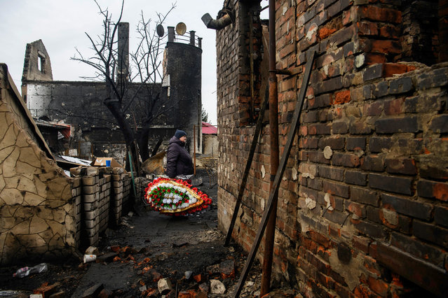 People are bringing toys, candles, and flowers in front of the house in Kharkiv, Ukraine, on February 12, 2024, where a family with their three children died in a fire following an attack by Russia's Shahed strike drones. (Photo by Maxym Marusenko/NurPhoto/Rex Features/Shutterstock)