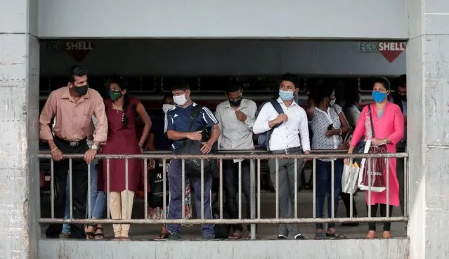 Passengers wearing protective masks wait for a bus at a main bus station, amid coronavirus disease (COVID-19) concerns, in Colombo, Sri Lanka, June 29, 2020. (Photo by Dinuka Liyanawatte/Reuters)