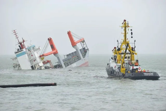 Dutch freighter Flinterstar is seen sinking after colliding with a tanker, the Marshall Island-flagged tanker Al-Oraiq, which also suffered damage in the collision, in the North Sea off the Belgian coast, October 6, 2015. (Photo by Benny Proot/Reuters)