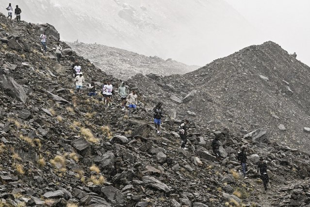 Runners compete in the first edition of the Annapurna Marathon in the foothills of the Mount Annapurna range in Myagdi on June 3, 2025. Dozens took part in the 42.5km (26.4 miles) marathon – downhill – from Annapurna Base camp as Nepal on June 3 celebrated 75 years since the first ascent of Mount Annapurna, the 10th highest peak in the world, led by French climber Maurice Herzog. (Photo by Prakash Mathema/AFP Photo)