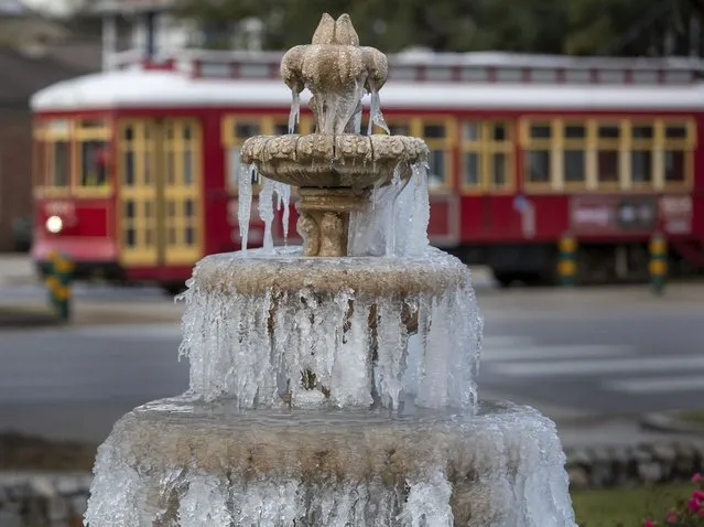 The fountain is frozen as temperatures hovered in the mid 20's at Jacob Schoen & Son Funeral Home in New Orleans, Saturday, December 24, 2022.  Millions of Americans are facing blinding blizzards, freezing rain, flooding and life-threatening cold through Christmas as a winter storm of unprecedented scope smashes its frigid way through most of the country. (Photo by David Grunfeld/The Advocate via AP Photo)