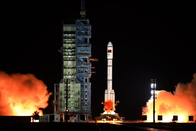 The Long March 7 rocket carrying the Tiangong-2 module blasts off from the Jiuquan Satellite Launch Center in Jiuquan, northwest China's Gansu Province, Thursday, September 15, 2016. China has launched its second space station in a sign of the growing sophistication of its military-backed program that intends to send a mission to Mars in the coming years. (Photo by Chinatopix via AP Photo)