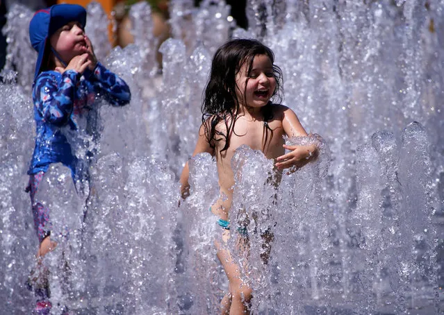 Children cool off in a fountain, amid the coronavirus disease (COVID-19) outbreak, in Shanghai, China on August 14, 2020. (Photo by Aly Song/Reuters)