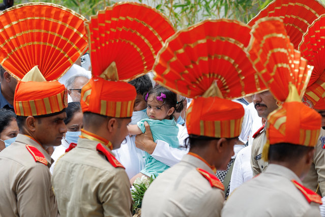 The grandaughter of former Chief Minister of Gujarat Vijay Rupani attends a wreath laying ceremony for Vijay Rupani, who died when an Air India Boeing 787-8 Dreamliner plane crashed during take-off from an airport, outside a mortuary at a hospital in Ahmedabad, India, on June 16, 2025. (Photo by Adnan Abidi/Reuters)