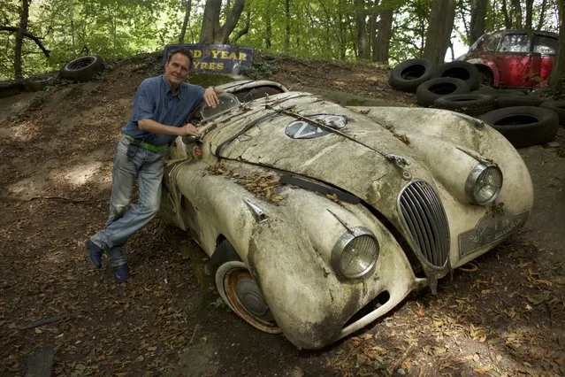 Michael stood next to his rotting Jaguar XK120 racecar that he used to win a grand prix in 1984 in Neandertal Germany, September 11, 2016. (Photo by Christoph Hagen/Barcroft Images)