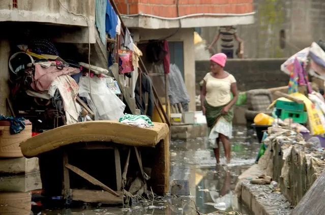 A woman rescue remains of her belongings from her apartment following rain fall at Oyebanjo Solarin Street in Ketu, Lagos which washed away a two yet to be identified children, after a heavy rainfall on Saturday in Lagos, on September 13, 2020. (Photo by Olukayode Jaiyeola/NurPhoto via Getty Images)