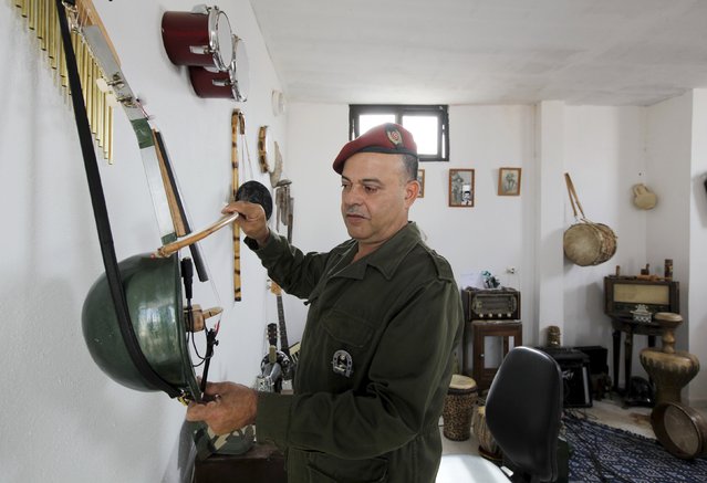 Tunisian Army retiree Belgacem Majri plays music using homemade musical instruments that he built using arms such as bombs and missiles, in Tunis, Tunisia October 20, 2015. (Photo by Anis Mili/Reuters)