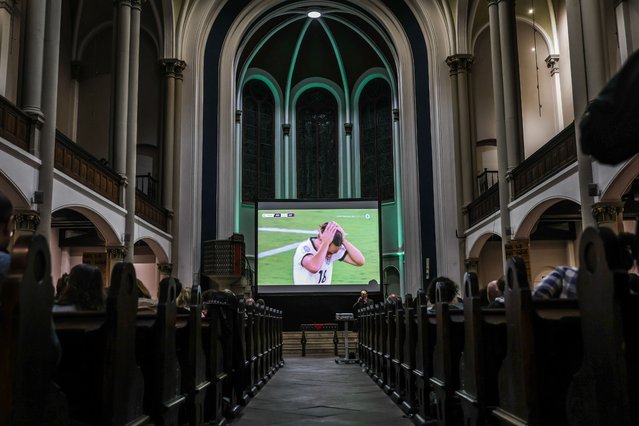 Fans watch the UEFA Women's EURO 2025 semifinal soccer match between Germany and Spain during public viewing in the Twelve Apostles Church in Berlin, Germany, 23 July 2025. People watch the match accompanied by live organ music instead of a TV commentator. (Photo by Filip Singer/EPA)