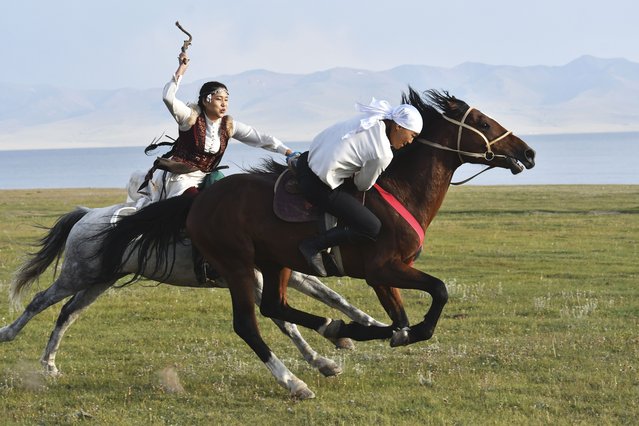 Participants of The Gallops' 2025 play the national equestrian game Kyz kuar during the competition near the alpine Song-Kol Lake, 280 km, (175 miles) southeast of Bishkek, Kyrgyzstan, Monday, July 21, 2025. (Photo by Vladimir Voronin/AP Photo)