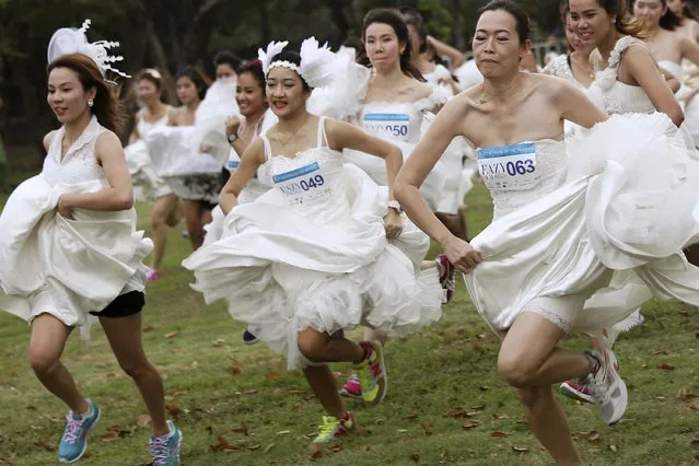 Brides-to-be participate in the “Running of the Brides” race in a park in Bangkok November 29, 2014. (Photo by Damir Sagolj/Reuters)