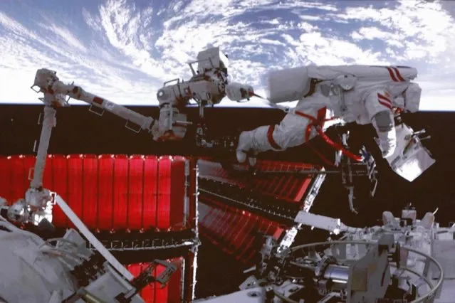 In this photo released by Xinhua News Agency, a video screen shows Chinese astronaut Fei Junlong conducting extravehicular activities on the orbiting Tiangong space station, Thursday, February 9, 2023. China's orbiting space station crew completed their first spacewalk on Friday out of several that are planned for their six-month mission. (Photo by Liu Fang/Xinhua via AP Photo)