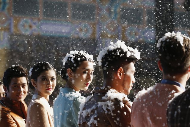 Model are seen covered with artificial snow flakes during a fashion show of VISCAP Yuan Bing collection at China Fashion Week in Beijing March 26, 2013.  The fashion week runs till March 30. (Photo by Kim Kyung-Hoon/Reuters)