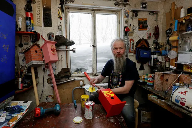 Vasily Slonov, 48, artist and supporter of presidential candidate Pavel Grudinin, poses for a picture inside his workshop in Krasnoyarsk, Russia, February 8, 2018. “I don't think that this will be Putin's final term in office. In fact I see a sort of messianic energy in Putin”, he said. “He’s not just any other person, but something of an instrument in God's hands. He's not simply a politician”. (Photo by Ilya Naymushin/Reuters)
