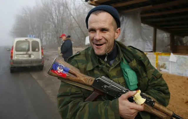 A pro-Russian rebel guards at the checkpoint outside of the town of Gorlovka northeast of Donetsk December 14, 2014. (Photo by Maxim Shemetov/Reuters)