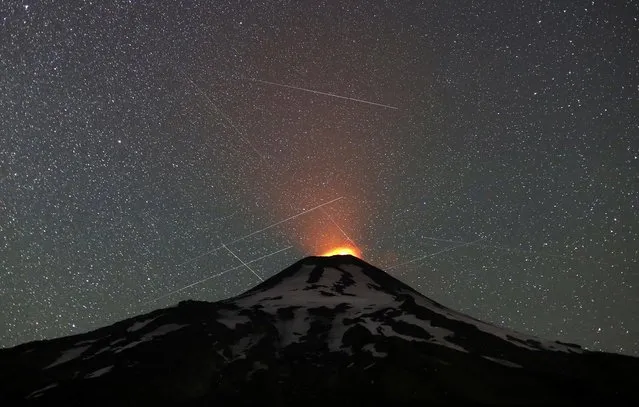 A general view of the Villarrica volcano from Pucon area, Chile on January 19, 2023. Picture taken using long exposure. (Photo by Albert Ibanez/Reuters)