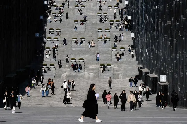 Students and visitors walk around the campus of Ewha Womans University in Seoul on March 2, 2023, which was founded in 1886. (Photo by Anthony Wallace/AFP Photo)