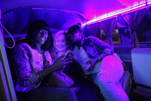 Women pose next to a life-size poster of the US Democratic presidential candidate Hillary Clinton outside the IFC Theater before the debut of a surprise documentary about US Republican presidential nominee Donald Trump titled “TrumpLand” made by US filmmaker Michael Moore in New York on October 18, 2016. (Photo by Kena Betancur/AFP Photo)