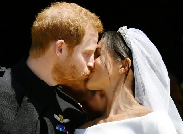 Prince Harry and Meghan Markle kiss on the steps of St George's Chapel in Windsor Castle after their wedding in Windsor, Britain, May 19, 2018. (Photo by Ben Birchall/Reuters)