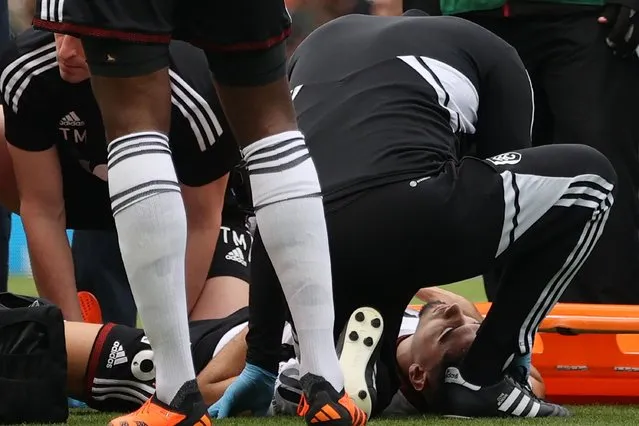 Fulham's Brazilian midfielder Andreas Pereira is treated by medical staff after falling badly during the English Premier League football match between Fulham and Manchester City at Craven Cottage in London on April 30, 2023. (Photo by Adrian Dennis/AFP Photo)