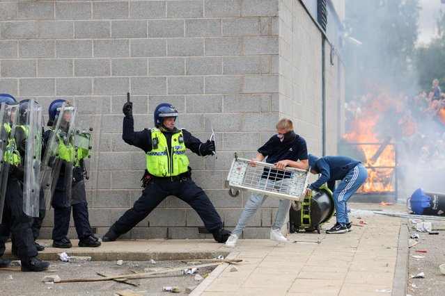 A police officer clashes with a protestor outside a hotel in Rotherham, Britain, on August 4, 2024. (Photo by Hollie Adams/Reuters)