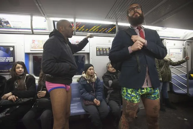 Participants taking part in the “No Pants Subway Ride” stand near passengers in the Manhattan borough of New York January 11, 2015. (Photo by Carlo Allegri/Reuters)