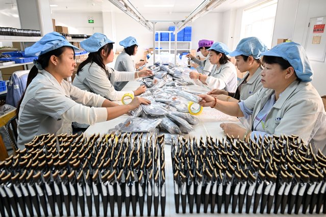 Staff members operate at a workshop of a makeup brush manufacturing enterprise in Qingxian County, Cangzhou, north China's Hebei Province, December 4, 2025. The makeup brush industry in Qingxian County, which burgeoned in the 1990s with a bunch of contract manufacturers, has evolved into a cluster of independent brands. In recent years, Qingxian has been continuously upgrading this sector through efforts such as the establishment of an industrial alliance, development of new materials, and building presence in platforms for cross-border e-commerce. Currently, the annual revenue of makeup brush enterprises in the county is approximately 3 billion yuan (about 425 million U.S. dollars). (Photo by Xinhua News Agency/Rex Features/Shutterstock)