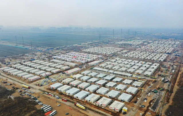 In this aerial photo released by China's Xinhua News Agency, construction workers build a quarantine center which, according to state media, will have over 4,000 rooms to isolate close contacts of COVID-19 cases in Shijiazhuang in northern China's Hebei Province, Wednesday, January 20, 2021. China is imposing some of its toughest travel restrictions yet as coronavirus cases surge in several northern provinces ahead of the Lunar New Year. (Photo by Yang Shiyao/Xinhua via AP Photo)