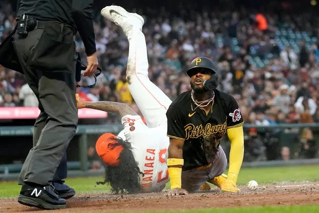 Pittsburgh Pirates' Rodolfo Castro, right, looks toward umpire Andy Fletcher, left, after scoring on a wild pitch by San Francisco Giants pitcher Sean Manaea, middle, during the fifth inning of a baseball game in San Francisco, Tuesday, May 30, 2023. (Photo by Jeff Chiu/AP Photo)