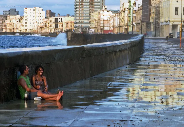 “Fun on the Malecon”. While strolling down the Malecon in Havana, Cuba, I came across this couple. They were laughing and drinking and getting soaked by an occasional wave that broke over the sea wall. They were oblivious to the rest of the world while they enjoyed each other immensely. (Photo and caption by Jim Tardio/National Geographic Traveler Photo Contest)