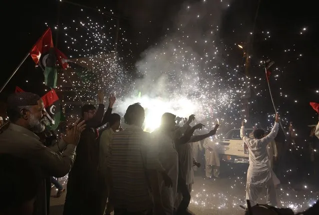Supporters of Pakistani opposition party hold firework to celebrate following the Supreme Court decision, in Karachi, Pakistan, Thursday, April 7, 2022. Pakistan's Supreme Court on Thursday blocked Prime Minister Imran Khan's bid to stay in power, ruling that his move to dissolve Parliament and call early elections was illegal. That set the stage for a no-confidence vote by opposition lawmakers, who say they have enough support to oust him. (Photo by Fareed Khan/AP Photo)